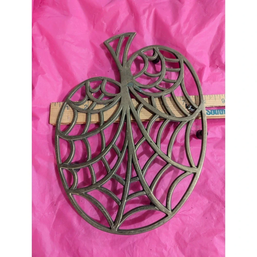 Brass color larger trivet web looking‎ leaf tree ?
